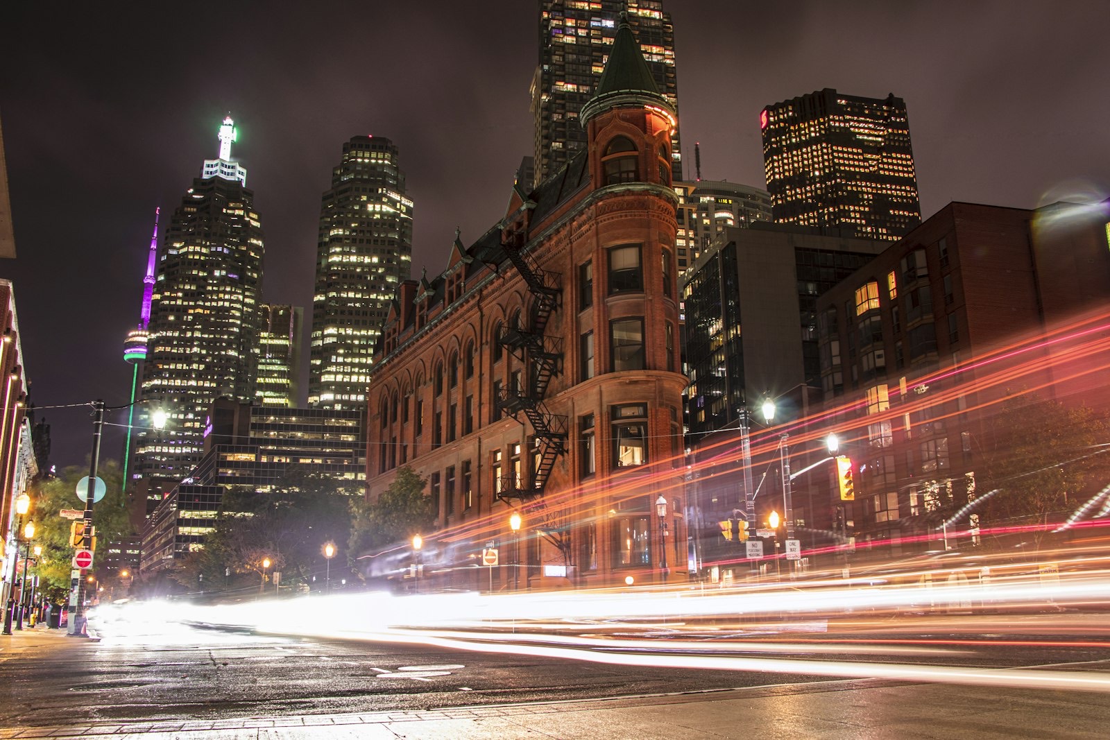 Light trails from traffic passing the Gooderham Building in Toronto at night